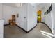 Open hallway with modern design and views into the next room with natural light, and simple flooring at 5896 Peregrine Trl, Golden, CO 80403