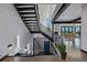 Open floor plan features a modern staircase and dining area with views at 5896 Peregrine Trl, Golden, CO 80403