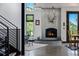 Unique living space with a cozy fireplace and scenic mountain views from large windows at 5896 Peregrine Trl, Golden, CO 80403