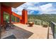 The outdoor patio area has a fireplace, lounge chairs, and an overview of the surrounding forest at 5896 Peregrine Trl, Golden, CO 80403