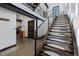 Modern staircase with wood treads, steel railings, and open design, offering a blend of industrial and contemporary style at 5896 Peregrine Trl, Golden, CO 80403