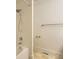 Tiled tub/shower combination with an adjustable shower head and neutral wall color at 19259 E Caspian Pl, Aurora, CO 80013