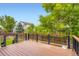 Wooden deck with dark railings, overlooking a grassy yard, trees and the neighborhood at 19259 E Caspian Pl, Aurora, CO 80013