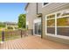 Wooden deck with black railings and a sliding glass door to the home's interior at 19259 E Caspian Pl, Aurora, CO 80013