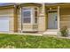 Traditional home featuring brick accents, landscaped lawn, and covered entryway at 19259 E Caspian Pl, Aurora, CO 80013