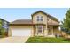 Charming home featuring a two-car garage and a well-manicured lawn at 19259 E Caspian Pl, Aurora, CO 80013