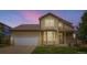 Charming home featuring a two-car garage and a well-manicured lawn at 19259 E Caspian Pl, Aurora, CO 80013