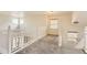 Upstairs hallway with windows, white railings, and carpet flooring at 19259 E Caspian Pl, Aurora, CO 80013