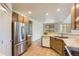 Well-lit kitchen featuring wooden cabinets and stainless steel appliances at 19259 E Caspian Pl, Aurora, CO 80013