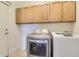 Laundry room with a front loading dryer, and storage cabinets above at 19259 E Caspian Pl, Aurora, CO 80013