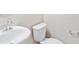 Clean bathroom with white sink, toilet, and grab bars at 8869 Sedalia St, Commerce City, CO 80022