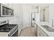 Modern kitchen with stainless steel appliances and white cabinets at 8869 Sedalia St, Commerce City, CO 80022