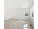 Bright living room with neutral walls and wood-look floors at 8869 Sedalia St, Commerce City, CO 80022