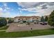 View of complex with assigned parking and trees at 908 S Yampa St # 208, Aurora, CO 80017