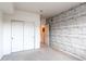 Bright bedroom features a gray shiplap accent wall and a closet with white sliding doors at 908 S Yampa St # 208, Aurora, CO 80017