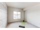 Bright bedroom featuring a window and light wood plank accent wall at 908 S Yampa St # 208, Aurora, CO 80017