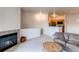 Open living area with fireplace flowing into kitchen space at 908 S Yampa St # 208, Aurora, CO 80017