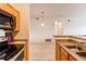 Open-concept living area with view of the kitchen, neutral walls, and carpeted flooring at 908 S Yampa St # 208, Aurora, CO 80017