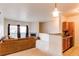 Sunlit living room with fireplace open to kitchen with bar seating at 908 S Yampa St # 208, Aurora, CO 80017