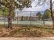 Well-maintained tennis court surrounded by trees and a secure fence at 908 S Yampa St # 208, Aurora, CO 80017