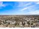 Wide aerial shot capturing a residential area featuring houses nestled amongst trees with mountain views in the background at 12532 Daniels Gate Dr, Castle Pines, CO 80108