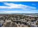 Expansive aerial view of a residential community with mountain views in the distance under a bright blue sky at 12532 Daniels Gate Dr, Castle Pines, CO 80108