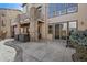 Spacious backyard featuring a stamped concrete patio, covered seating area, stone columns, and outdoor grill at 12532 Daniels Gate Dr, Castle Pines, CO 80108