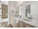 Modern bathroom with double sinks, white countertops, and a tiled shower at 12532 Daniels Gate Dr, Castle Pines, CO 80108