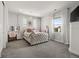 Elegant bedroom with a tufted headboard, vanity area, and large windows for natural light at 12532 Daniels Gate Dr, Castle Pines, CO 80108