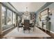 Formal dining room with large windows, chandelier, and elegant table setting for sophisticated entertaining at 12532 Daniels Gate Dr, Castle Pines, CO 80108