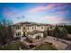 Stunning two-story stucco home boasting stone accents, manicured lawn, and a winding driveway leading to a two car garage at 12532 Daniels Gate Dr, Castle Pines, CO 80108