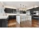 Modern kitchen with dark cabinets, marble countertops, and stainless steel appliances at 12532 Daniels Gate Dr, Castle Pines, CO 80108