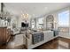 Bright living room featuring hardwood floors, elegant seating, and sophisticated chandelier lighting at 12532 Daniels Gate Dr, Castle Pines, CO 80108