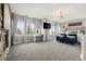 Spacious main bedroom featuring a fireplace, sitting area, and large windows for ample natural light at 12532 Daniels Gate Dr, Castle Pines, CO 80108