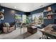 Stylish home office with custom desk, a sitting area, and shelving for books and decor at 12532 Daniels Gate Dr, Castle Pines, CO 80108