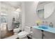 Unique powder room with blue sink and modern mirror at 12532 Daniels Gate Dr, Castle Pines, CO 80108