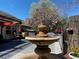 Beautiful backyard with a fountain, pergola, deck, and flowering tree creates a serene outdoor living space at 6681 E Phillips Pl, Centennial, CO 80112