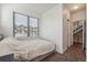 Sun-filled bedroom includes stairs, neutral colors, and a view of the community at 1216 Perry St, Denver, CO 80204