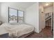 Bright bedroom featuring a double bed, light gray carpet, and large window providing lots of natural light at 1216 Perry St, Denver, CO 80204