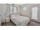 A sunlit bedroom with a double bed and a door that brings in extra light at 1216 Perry St, Denver, CO 80204