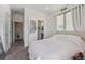 Bright, minimalist bedroom with neutral tones, offering access to closet and ensuite bathroom at 1216 Perry St, Denver, CO 80204