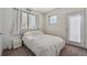 Bright bedroom featuring a double bed, light gray carpet, and large window providing lots of natural light at 1216 Perry St, Denver, CO 80204