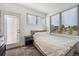 Bright bedroom featuring a double bed, light gray carpet, and large window providing lots of natural light at 1216 Perry St, Denver, CO 80204