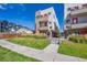 Modern townhome exterior featuring vibrant orange accents and well-maintained landscaping on a sunny day at 1216 Perry St, Denver, CO 80204