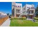 Modern townhouse with a well-maintained lawn, contemporary design, and colorful red accents at 1216 Perry St, Denver, CO 80204