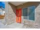 Modern building exterior with orange front door and brick accents at 1216 Perry St, Denver, CO 80204