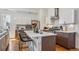 Modern kitchen features a large island, white cabinets, stainless steel appliances, and a tile backsplash at 1216 Perry St, Denver, CO 80204