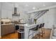 Open concept kitchen showcasing an island with bar seating, stainless appliances, and modern cabinetry at 1216 Perry St, Denver, CO 80204