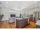 Open kitchen featuring a center island, stainless appliances, and seamless flow into the living area at 1216 Perry St, Denver, CO 80204