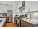 Modern kitchen with stainless steel appliances, white subway tile backsplash, and quartz countertops at 1216 Perry St, Denver, CO 80204